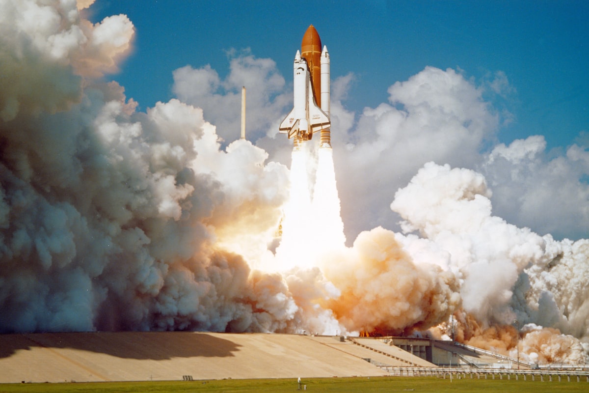 Space shuttle lifting off from the launch pad